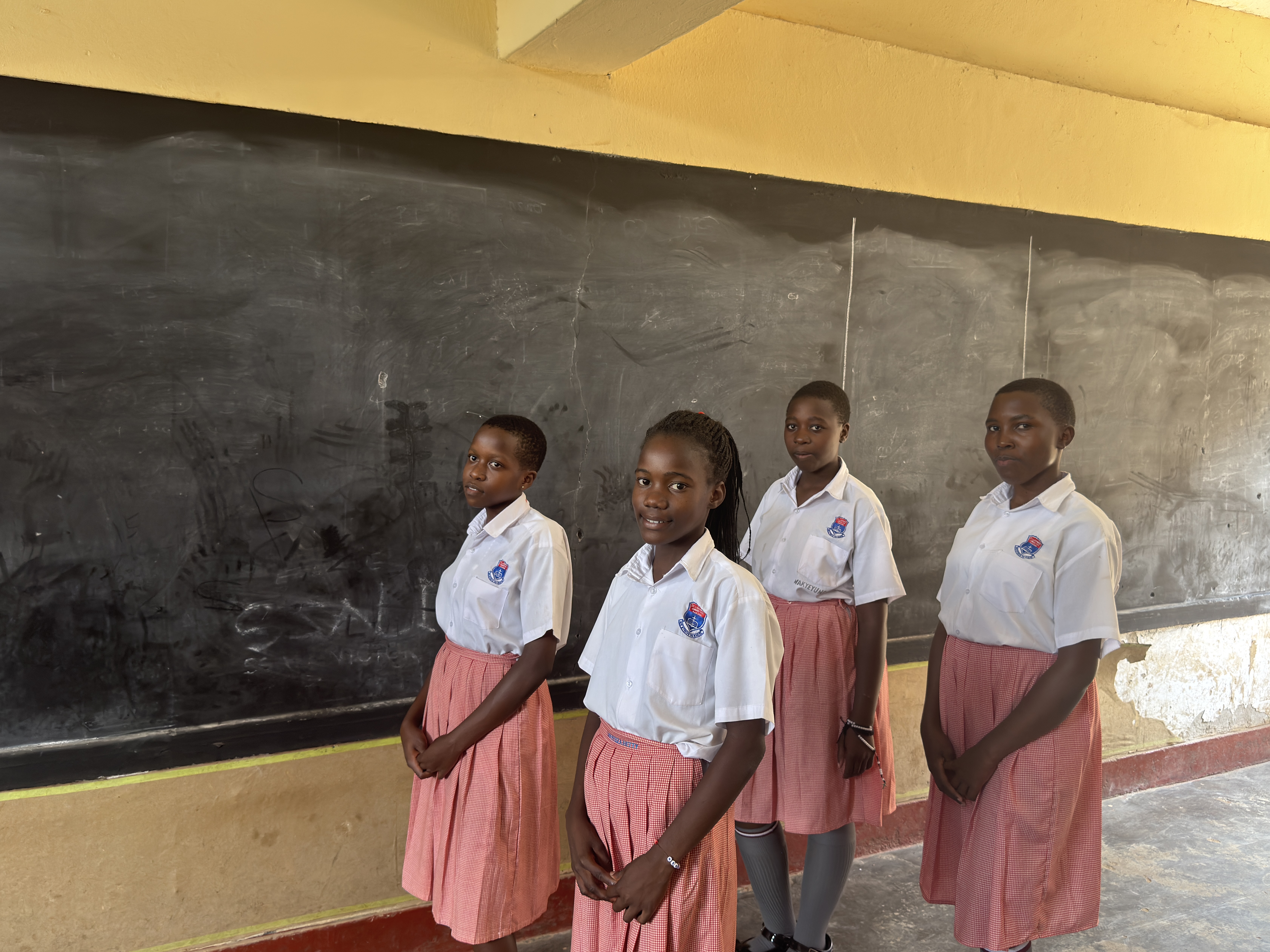 St. Lawrence Junior School Kabowa pupils smiling in uniform